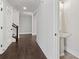 Hallway featuring hardwood floors and white walls connecting rooms and a half bathroom at 682 Shelton Sw Ave, Atlanta, GA 30310