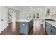 Modern kitchen with gray cabinets, quartz countertops, stainless steel appliances, and an island at 682 Shelton Sw Ave, Atlanta, GA 30310