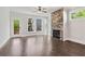 Open living room with hardwood floors and a stone fireplace provides a cozy space at 682 Shelton Sw Ave, Atlanta, GA 30310