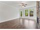Hardwood floors, natural light, and a stone fireplace accent this airy and bright living space at 682 Shelton Sw Ave, Atlanta, GA 30310