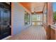 Spacious covered porch featuring wood flooring and a stylish pendant light fixture at 682 Shelton Sw Ave, Atlanta, GA 30310