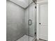 Modern bathroom showcasing a glass-enclosed shower with gray tiling and matching hexagon tile floor at 682 Shelton Sw Ave, Atlanta, GA 30310