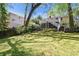 Large, grassy back yard with a white staircase leading up to a screened in porch and deck at 2585 Acorn Ne Ave, Atlanta, GA 30305