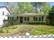 Charming single-story home with fresh landscaping and a manicured lawn in a serene, tree-lined neighborhood at 2585 Acorn Ne Ave, Atlanta, GA 30305