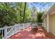 Spacious wooden deck perfect for outdoor gatherings with a large table and surrounded by lush trees at 2585 Acorn Ne Ave, Atlanta, GA 30305