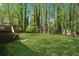 Spacious backyard with lush green grass, wooden fence, and mature trees offering privacy at 3362 Timber Rdg, Powder Springs, GA 30127