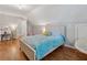 Bedroom with hardwood floors, a white bed, and a desk with a vanity area at 3362 Timber Rdg, Powder Springs, GA 30127