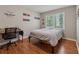 Simple bedroom featuring a baseball theme, a desk, a window, and hardwood floors at 3362 Timber Rdg, Powder Springs, GA 30127