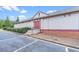 Commercial building with parking spaces, red door, and well maintained green landscape at 3362 Timber Rdg, Powder Springs, GA 30127