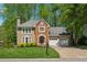 Traditional two-story house with a well-manicured lawn, brick facade, and an attached two-car garage at 3362 Timber Rdg, Powder Springs, GA 30127