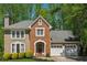 Charming two-story home features a brick facade, attached two-car garage and mature landscaping at 3362 Timber Rdg, Powder Springs, GA 30127