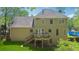 Exterior rear view of a two-story home featuring a deck, well-maintained lawn, and lush greenery at 3362 Timber Rdg, Powder Springs, GA 30127