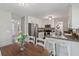 Spacious kitchen with bright white cabinets, stainless appliances, dark counters, and an eat-in dining area at 3362 Timber Rdg, Powder Springs, GA 30127