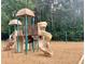Community playground with slides, swings, and climbing structures set on a wood chip surface at 3362 Timber Rdg, Powder Springs, GA 30127
