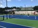 Outdoor tennis courts with players enjoying the game and nice lighting at 3362 Timber Rdg, Powder Springs, GA 30127