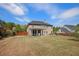 Large backyard with a covered patio, green grass, and a wood fence at 6150 Birchfield Trl, Cumming, GA 30041