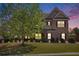 Beautiful two-story brick home with a well manicured front lawn and mature trees at 6150 Birchfield Trl, Cumming, GA 30041