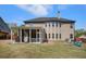 The exterior backyard offers a large screened porch and stone fire pit at 6150 Birchfield Trl, Cumming, GA 30041