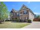 Charming two-story brick home with manicured lawn and vibrant landscaping in a Gathering-friendly neighborhood at 6150 Birchfield Trl, Cumming, GA 30041