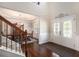 Welcoming foyer with hardwood floors and a staircase leading to a formal dining room, creating an elegant entryway at 6150 Birchfield Trl, Cumming, GA 30041