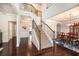 Elegant foyer with hardwood floors, a staircase, and a view into the formal dining room, setting a sophisticated tone at 6150 Birchfield Trl, Cumming, GA 30041