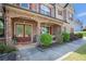 Inviting brick-arched front porch with double doors and meticulous landscaping for a warm, welcoming entrance at 6150 Birchfield Trl, Cumming, GA 30041