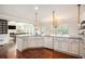 Well-equipped kitchen with granite countertops and stainless steel appliances with open view at 6150 Birchfield Trl, Cumming, GA 30041