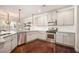 Bright kitchen with stainless steel appliances and updated white cabinets at 6150 Birchfield Trl, Cumming, GA 30041