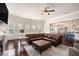 Spacious living room with a cozy fireplace, plush seating, and an open layout leading to the kitchen and dining area at 6150 Birchfield Trl, Cumming, GA 30041