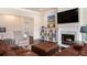 Charming living room featuring a stylish fireplace, entertainment center, and comfortable seating at 6150 Birchfield Trl, Cumming, GA 30041