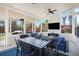 The screened porch offers a ceiling fan, outdoor seating, and tv at 6150 Birchfield Trl, Cumming, GA 30041