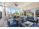 The screened porch offers a fire pit, outdoor seating, and ceiling fan at 6150 Birchfield Trl, Cumming, GA 30041