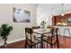 A contemporary dining area with dark wood floors, chandelier, and adjacent to the kitchen area at 711 Cosmopolitan Ne Dr # 347, Atlanta, GA 30324