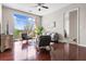 Bright living room with hardwood floors, a ceiling fan, stylish furniture, and a view of the outside at 711 Cosmopolitan Ne Dr # 347, Atlanta, GA 30324
