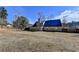 Expansive backyard featuring fencing, a screened sunroom, and a well-maintained lawn at 90 Ashford Dr, Oxford, GA 30054