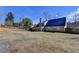 A large, fenced backyard with an enclosed sunroom featuring multiple windows at 90 Ashford Dr, Oxford, GA 30054
