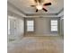 Comfortable main bedroom featuring tray ceiling, ceiling fan, neutral carpet and large windows at 90 Ashford Dr, Oxford, GA 30054