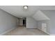 Spacious bonus room with neutral carpeting, gray walls, and textured ceiling at 90 Ashford Dr, Oxford, GA 30054