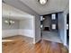 Open-concept dining area with hardwood floors, wainscoting, and natural light at 90 Ashford Dr, Oxford, GA 30054