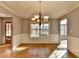 Elegant dining room with hardwood floors, wainscoting, and natural light at 90 Ashford Dr, Oxford, GA 30054