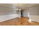 Dining area with wainscoting and hardwood floors, illuminated by a chandelier at 90 Ashford Dr, Oxford, GA 30054