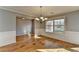 Spacious dining room with hardwood floors, wainscoting, and a modern chandelier at 90 Ashford Dr, Oxford, GA 30054