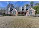 Charming two-story home with a well-maintained lawn and brick facade at 90 Ashford Dr, Oxford, GA 30054
