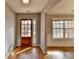 Bright foyer with hardwood floors, decorative lighting, and a view to the living space at 90 Ashford Dr, Oxford, GA 30054