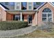 Welcoming brick home entrance featuring a covered porch and arched window at 90 Ashford Dr, Oxford, GA 30054