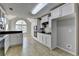 Well-lit kitchen boasts white cabinetry, stainless steel appliances, and tiled floors at 90 Ashford Dr, Oxford, GA 30054