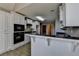 Kitchen with bar seating is open to multiple rooms in the house at 90 Ashford Dr, Oxford, GA 30054