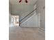 Bright living room features staircase, tall ceilings, and neutral colored walls and carpet at 90 Ashford Dr, Oxford, GA 30054