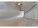 Spacious living room featuring a staircase, tall ceilings, carpet, and neutral wall color at 90 Ashford Dr, Oxford, GA 30054