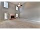Spacious living room featuring a fireplace, tall ceilings, ceiling fan, and a door to the exterior at 90 Ashford Dr, Oxford, GA 30054